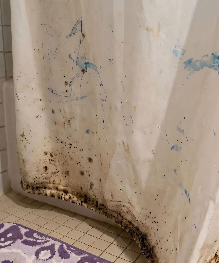 A stained shower curtain with blue marks, hanging above a tiled floor.